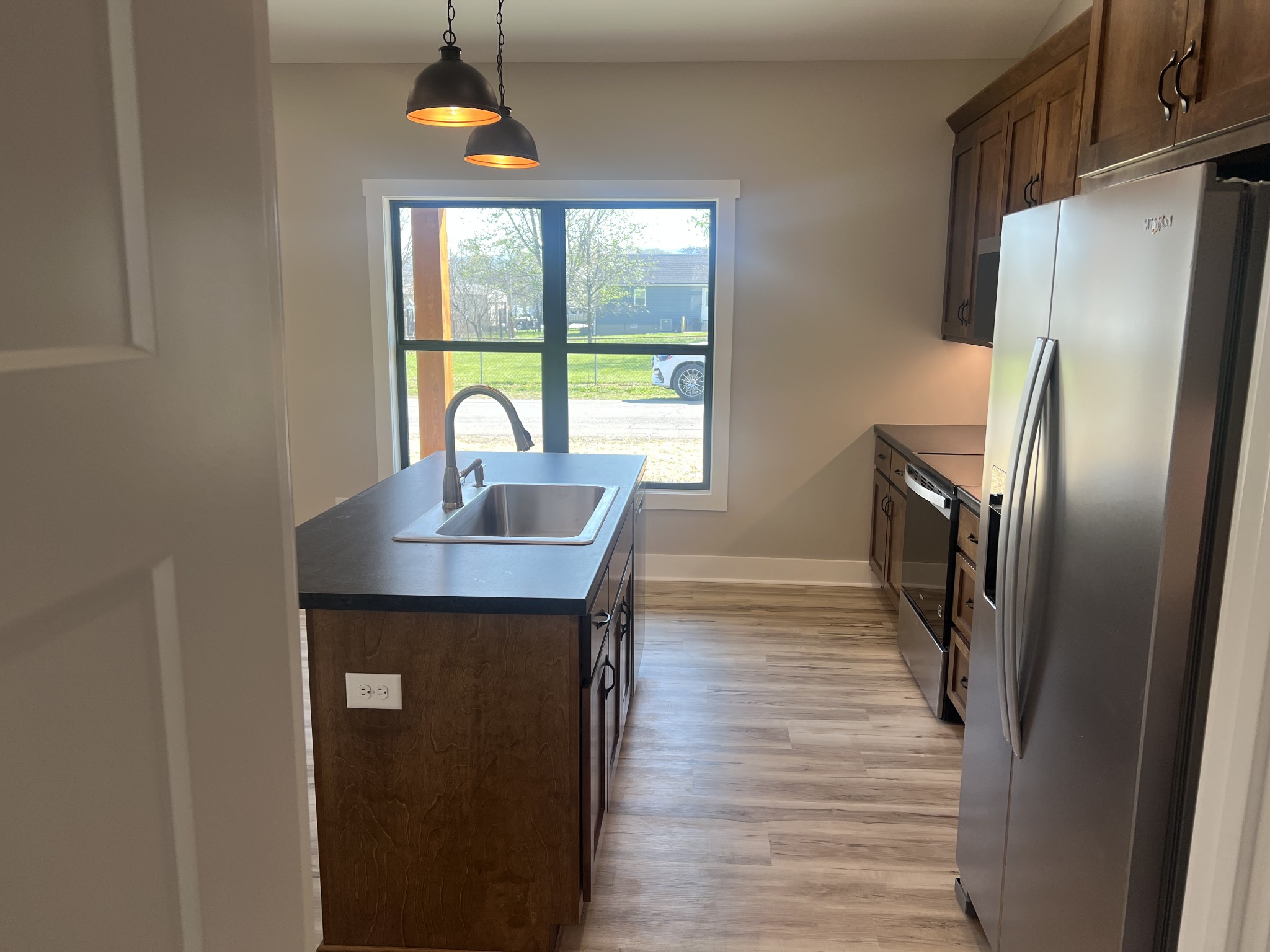 401 Hawkins Street Cowan, TN 37318 - Photo 4 of 15 a kitchen with stainless steel appliances a dining table chairs and a window