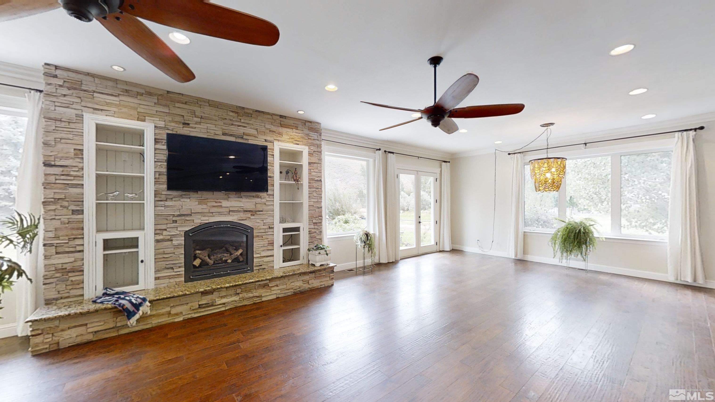 22850 Carriage Drive Reno, NV 89521 - Photo 8 of 35 a view of a livingroom with a fireplace window and wooden floor