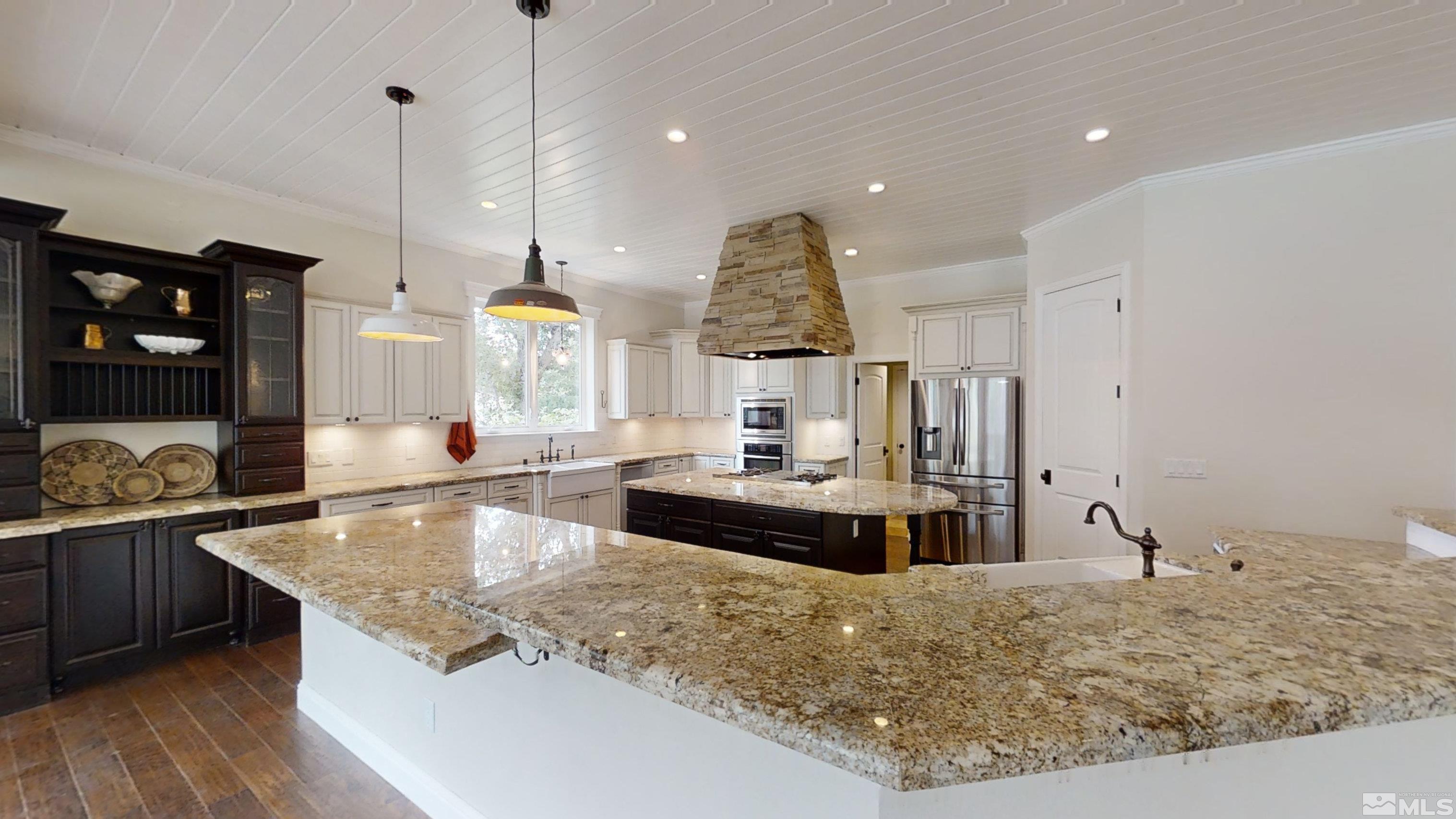 22850 Carriage Drive Reno, NV 89521 - Photo 10 of 35 a large kitchen with kitchen island granite countertop a large counter top and sink
