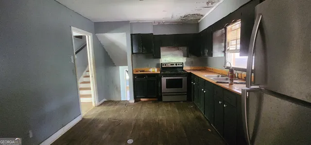 a kitchen with stainless steel appliances a refrigerator and a stove