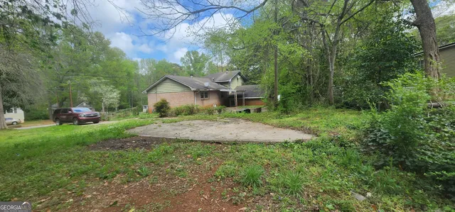 a view of a house with yard and a garden