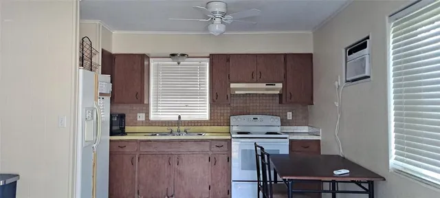 a kitchen with a sink cabinets and window