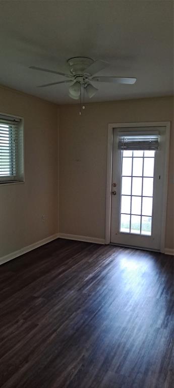 1118 Highway 441 Okeechobee, FL 34974 - Photo 6 of 11 an empty room with wooden floor and windows