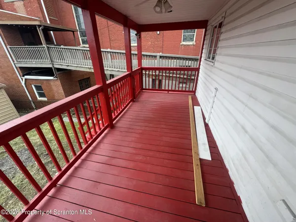 a view of balcony with wooden floor