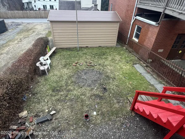 a view of a backyard with chairs