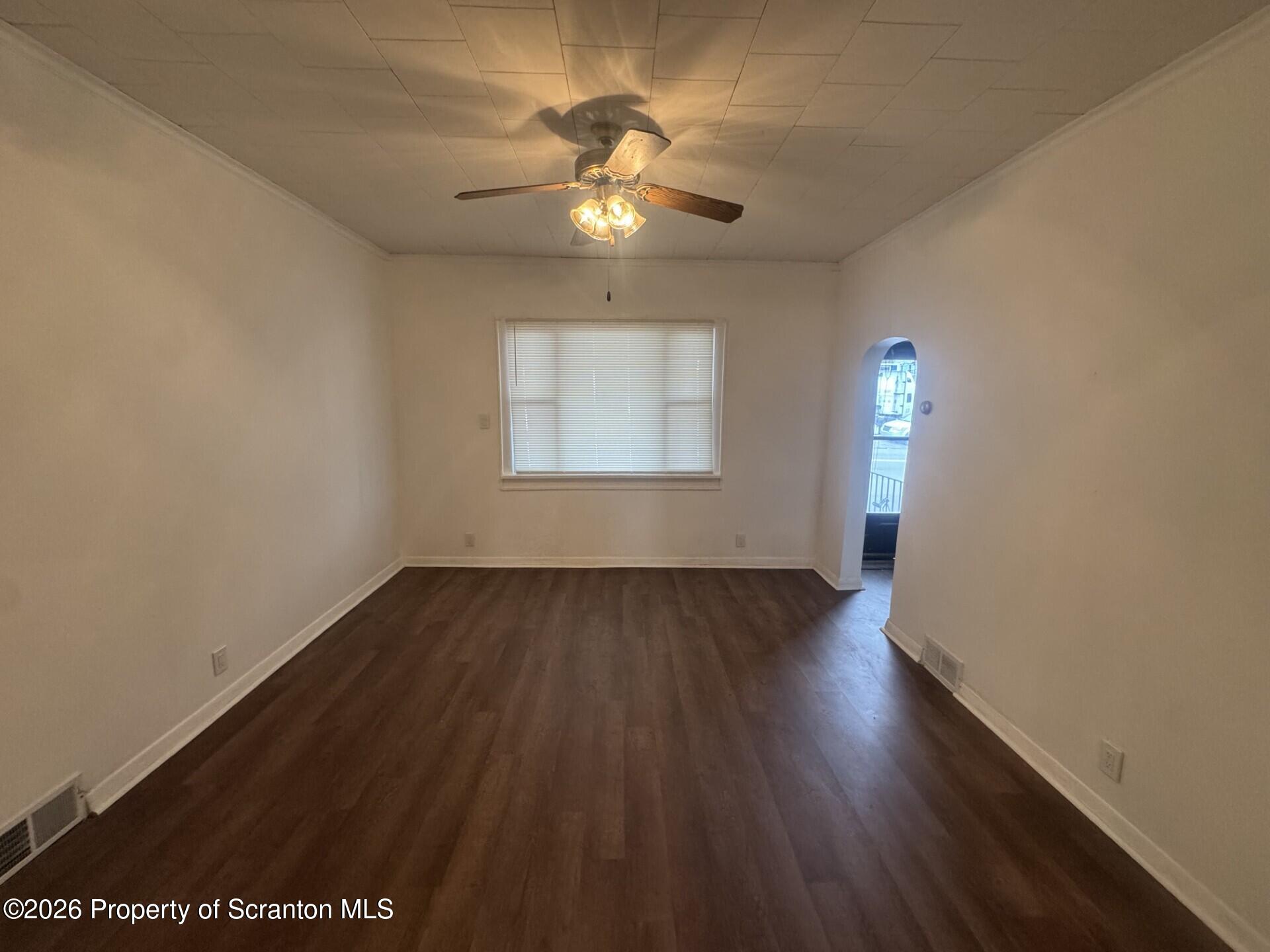 209 South Main Avenue Scranton, PA 18504 - Photo 6 of 12 an empty room with wooden floor chandelier fan and windows