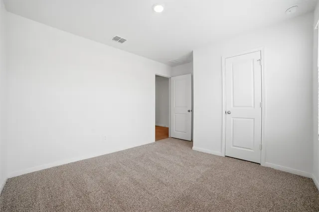 a large white kitchen with cabinets a sink and stainless steel appliances