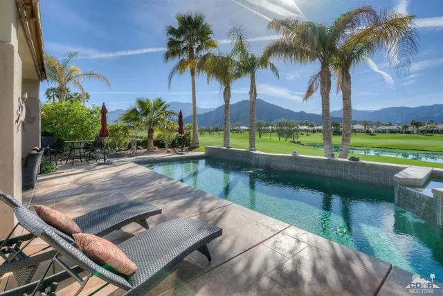 a view of swimming pool with a patio and a yard