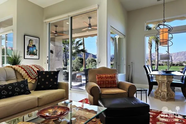 a living room with furniture a lamp and a window