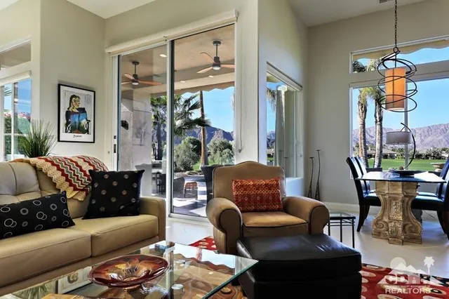 a living room with furniture a lamp and a window