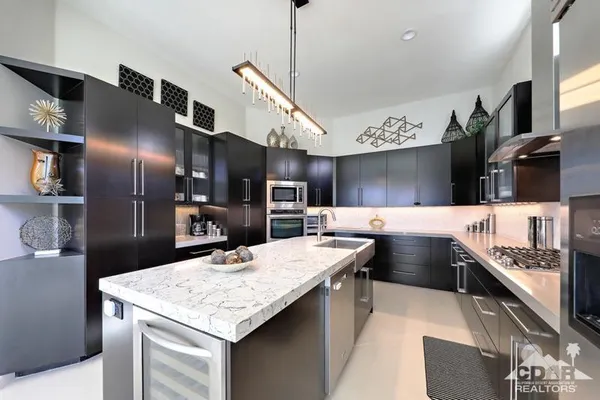 a kitchen with stainless steel appliances kitchen island granite countertop a sink and cabinets