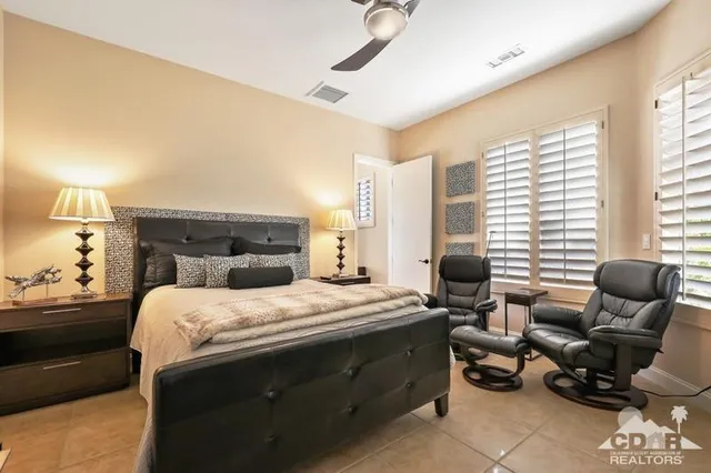 a bedroom with a bed and a couch