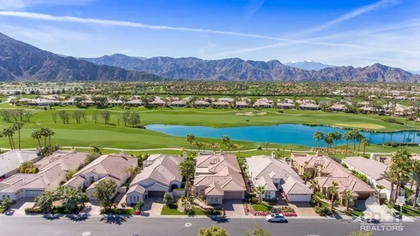 an aerial view of residential houses with outdoor space and river