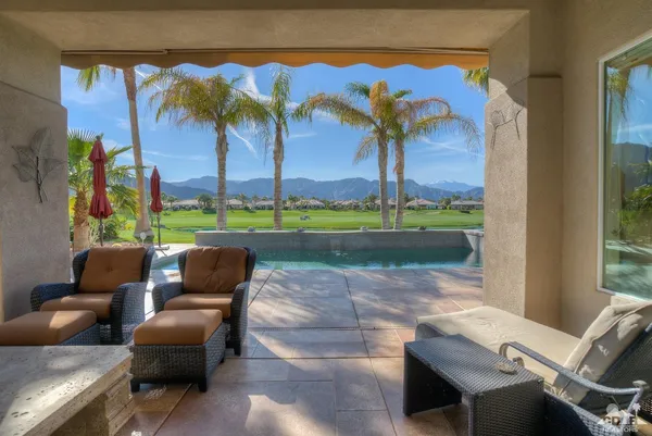a view of a patio with couches and pool