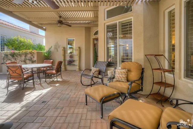 a view of a patio with table and chairs