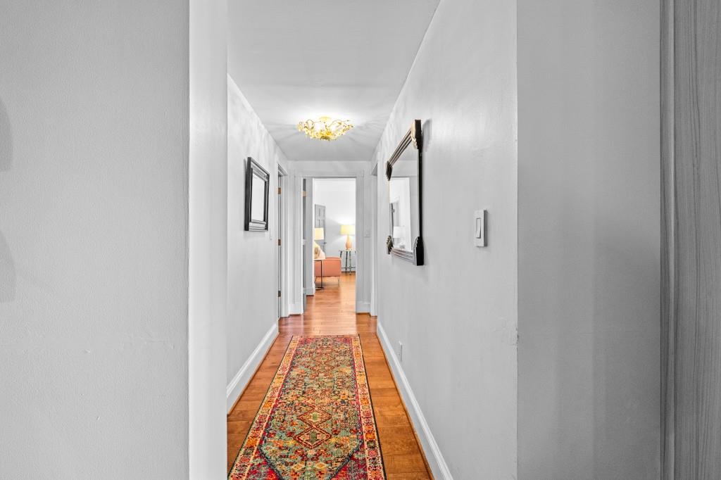 3638 Peachtree Road Northeast, Unit 406 Atlanta, GA 30319 - Photo 15 of 27 a view of a hallway with wooden floor and staircase