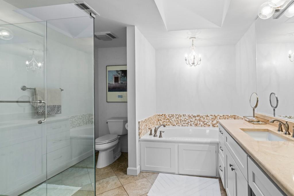 3638 Peachtree Road Northeast, Unit 406 Atlanta, GA 30319 - Photo 19 of 27 a bathroom with a sink toilet and shower