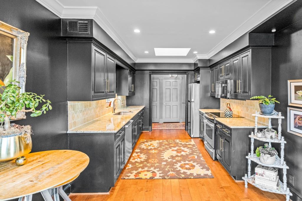 3638 Peachtree Road Northeast, Unit 406 Atlanta, GA 30319 - Photo 24 of 27 a kitchen with stainless steel appliances granite countertop a sink and a refrigerator