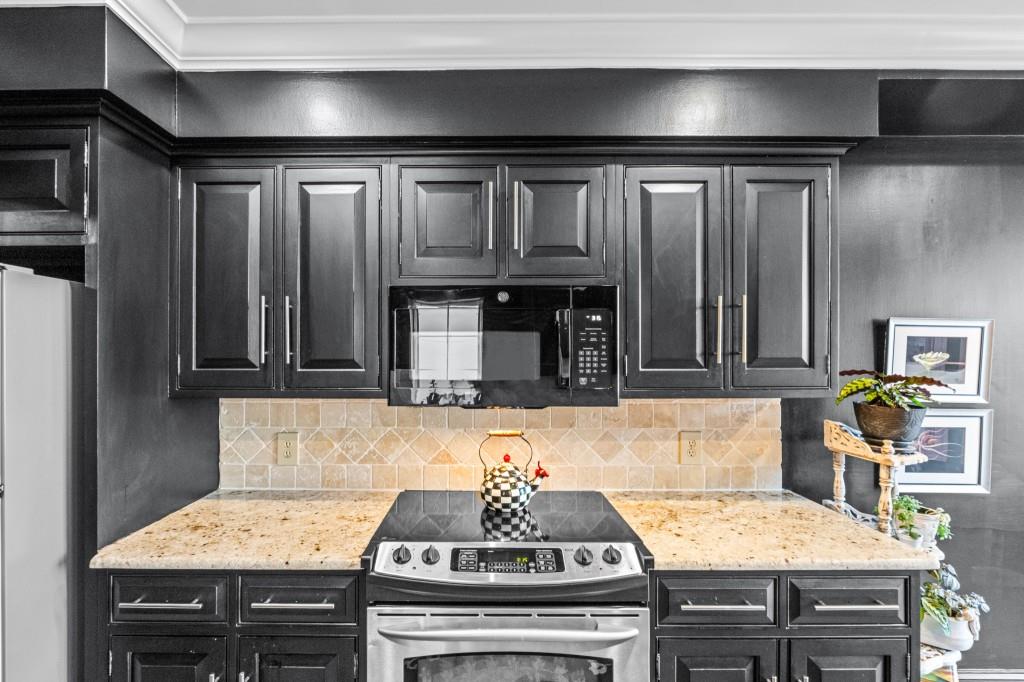 3638 Peachtree Road Northeast, Unit 406 Atlanta, GA 30319 - Photo 26 of 27 a kitchen with granite countertop a stove and cabinets