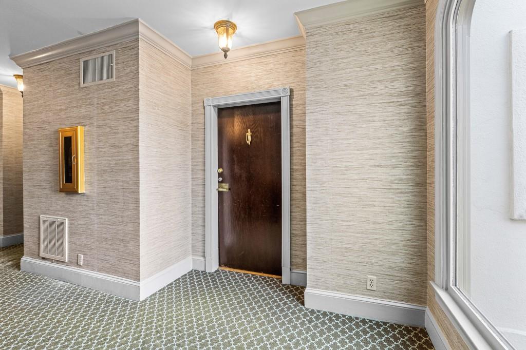 3638 Peachtree Road Northeast, Unit 406 Atlanta, GA 30319 - Photo 6 of 27 a view of a hallway with wooden cabinets