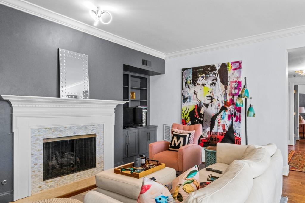 3638 Peachtree Road Northeast, Unit 406 Atlanta, GA 30319 - Photo 8 of 27 a living room with furniture and a fireplace