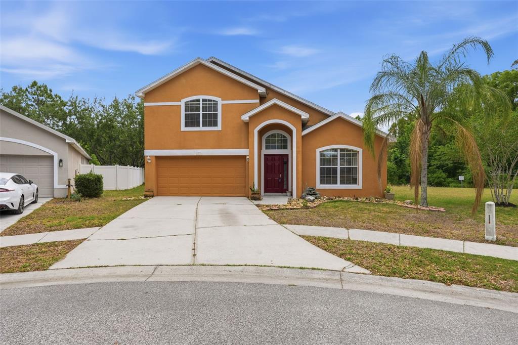 a front view of a house with a yard and garage