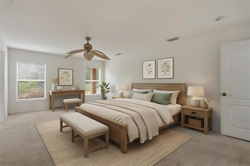 12005 Infinity Drive New Port Richey, FL 34654 - Photo 16 of 48 a spacious bedroom with a bed and wooden floor