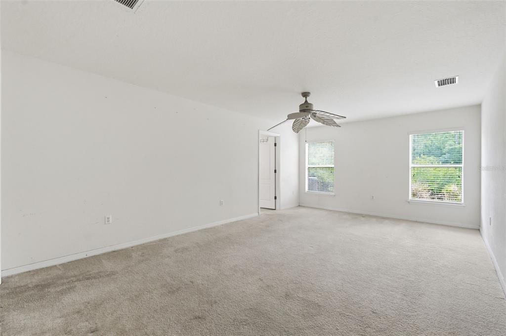 12005 Infinity Drive New Port Richey, FL 34654 - Photo 17 of 48 a view of a big room with windows and chandelier fan