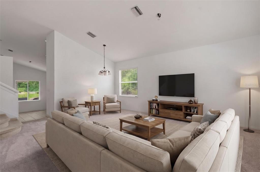 12005 Infinity Drive New Port Richey, FL 34654 - Photo 3 of 48 a living room with furniture and a flat screen tv