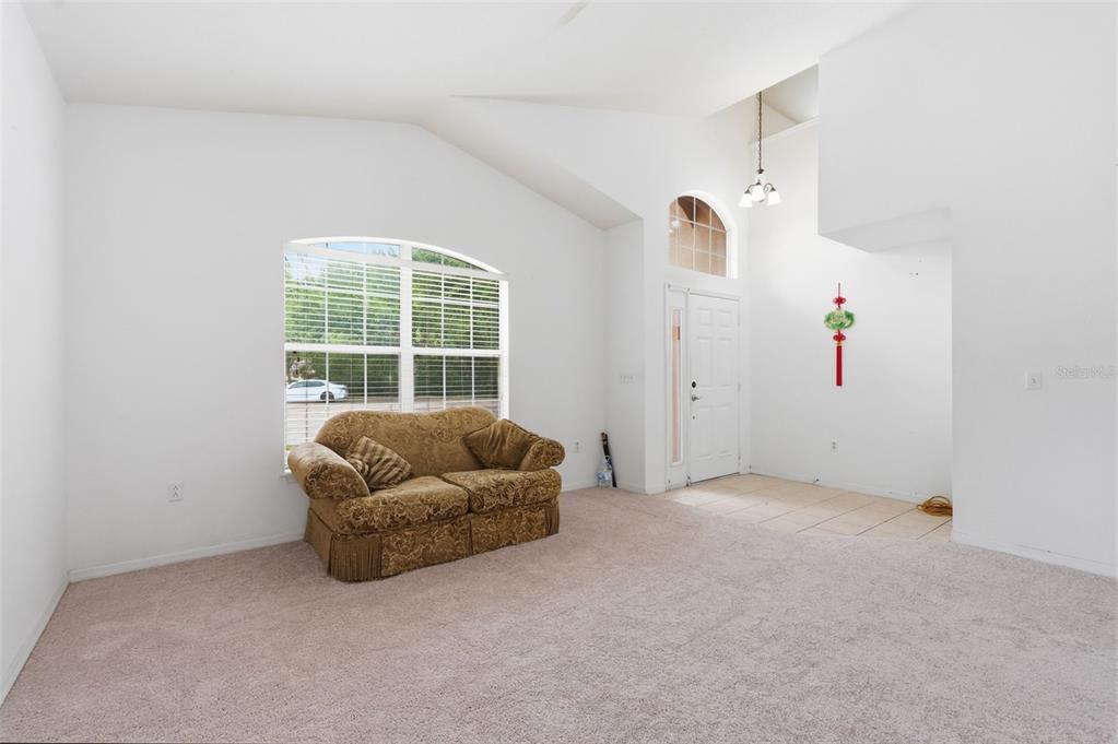12005 Infinity Drive New Port Richey, FL 34654 - Photo 5 of 48 a living room with furniture and white walls
