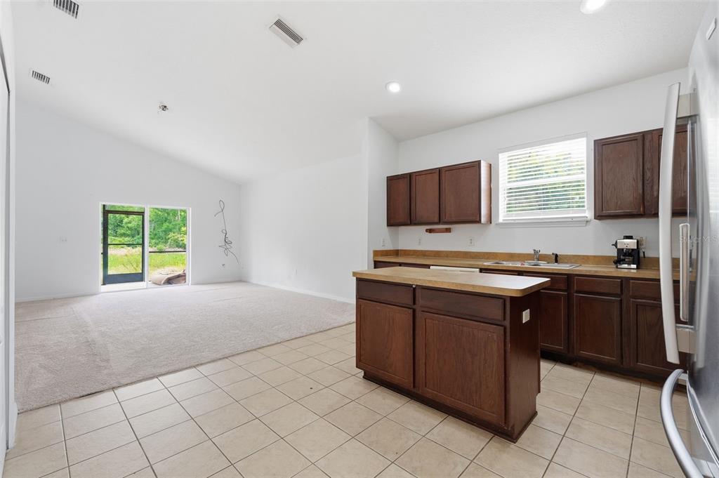 12005 Infinity Drive New Port Richey, FL 34654 - Photo 7 of 48 a kitchen with stainless steel appliances granite countertop a stove and a sink