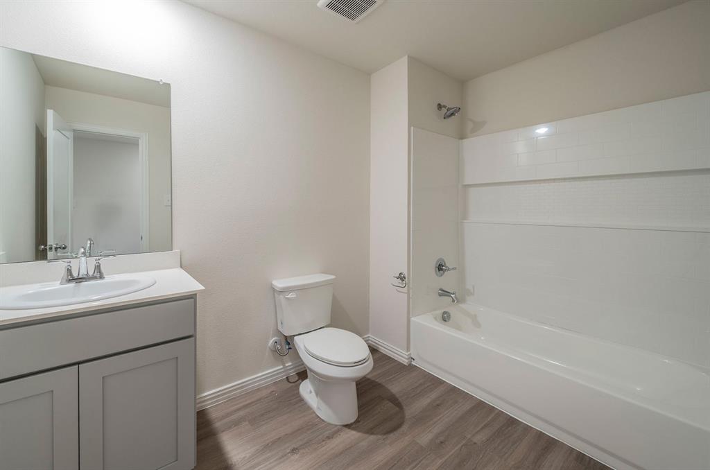 118 Goel Street Greenville, TX 75402 - Photo 9 of 12 a bathroom with a toilet sink and a mirror