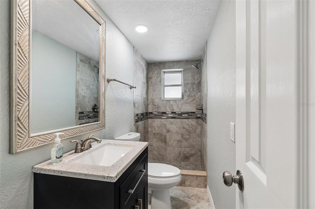 4417 Rudder Way New Port Richey, FL 34652 - Photo 12 of 47 a bathroom with a sink toilet and mirror