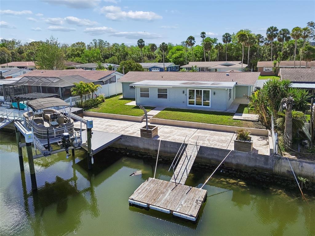 4417 Rudder Way New Port Richey, FL 34652 - Photo 25 of 47 a aerial view of a house with swimming pool and a yard