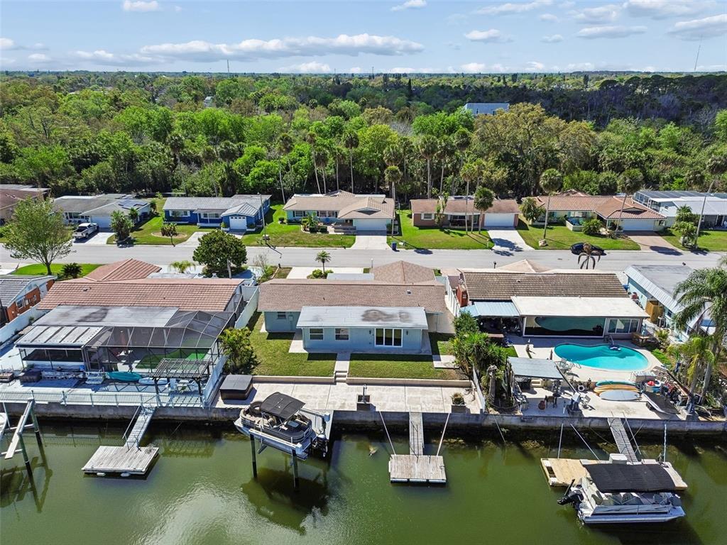4417 Rudder Way New Port Richey, FL 34652 - Photo 26 of 47 a aerial view of a swimming pool with outdoor seating and a garden
