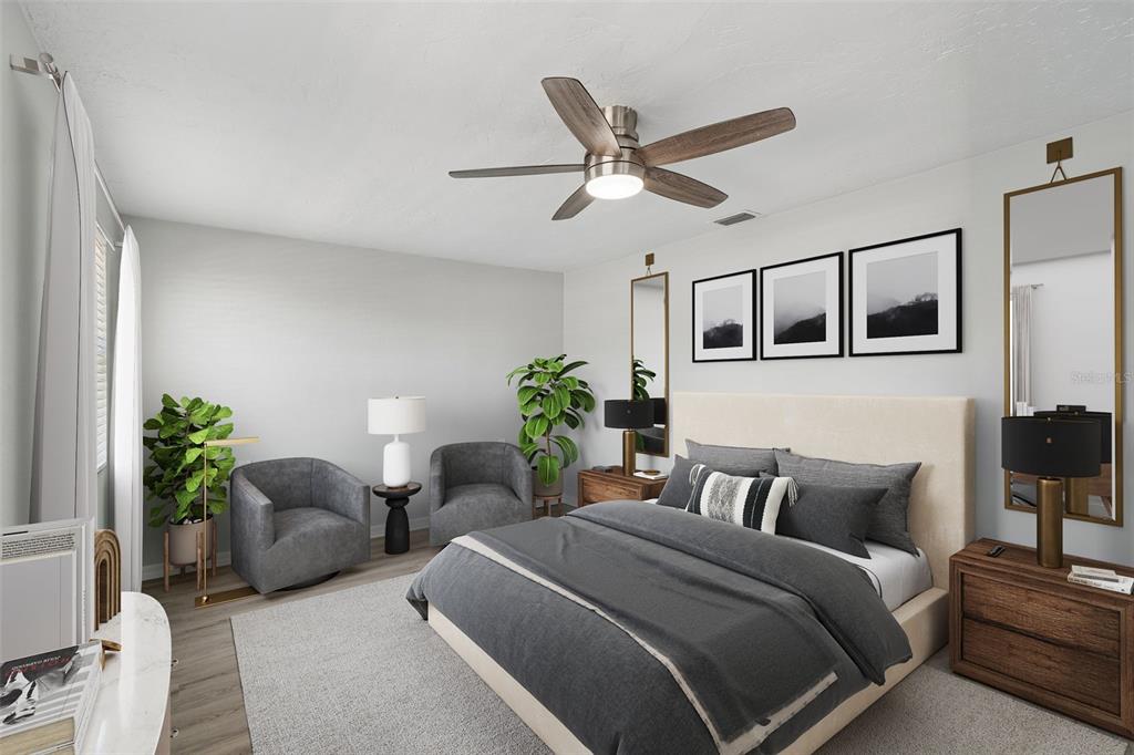 4417 Rudder Way New Port Richey, FL 34652 - Photo 8 of 47 a spacious bedroom with a bed a chandelier and a potted plant