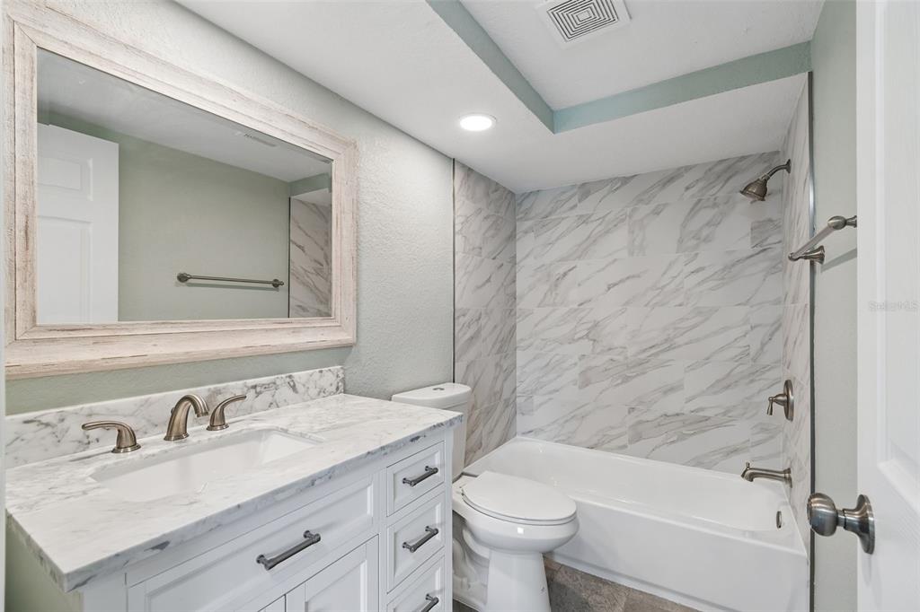 4417 Rudder Way New Port Richey, FL 34652 - Photo 9 of 47 a bathroom with a granite countertop sink toilet and shower