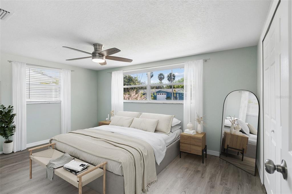 4417 Rudder Way New Port Richey, FL 34652 - Photo 10 of 47 a bedroom with a bed and a large window with wooden floor