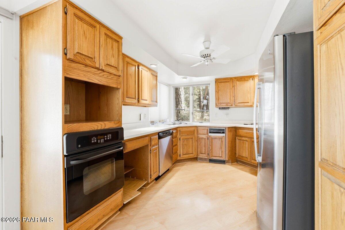 748 East Marapai Road Prescott, AZ 86303 - Photo 16 of 47 a kitchen with stainless steel appliances a stove cabinets and a window