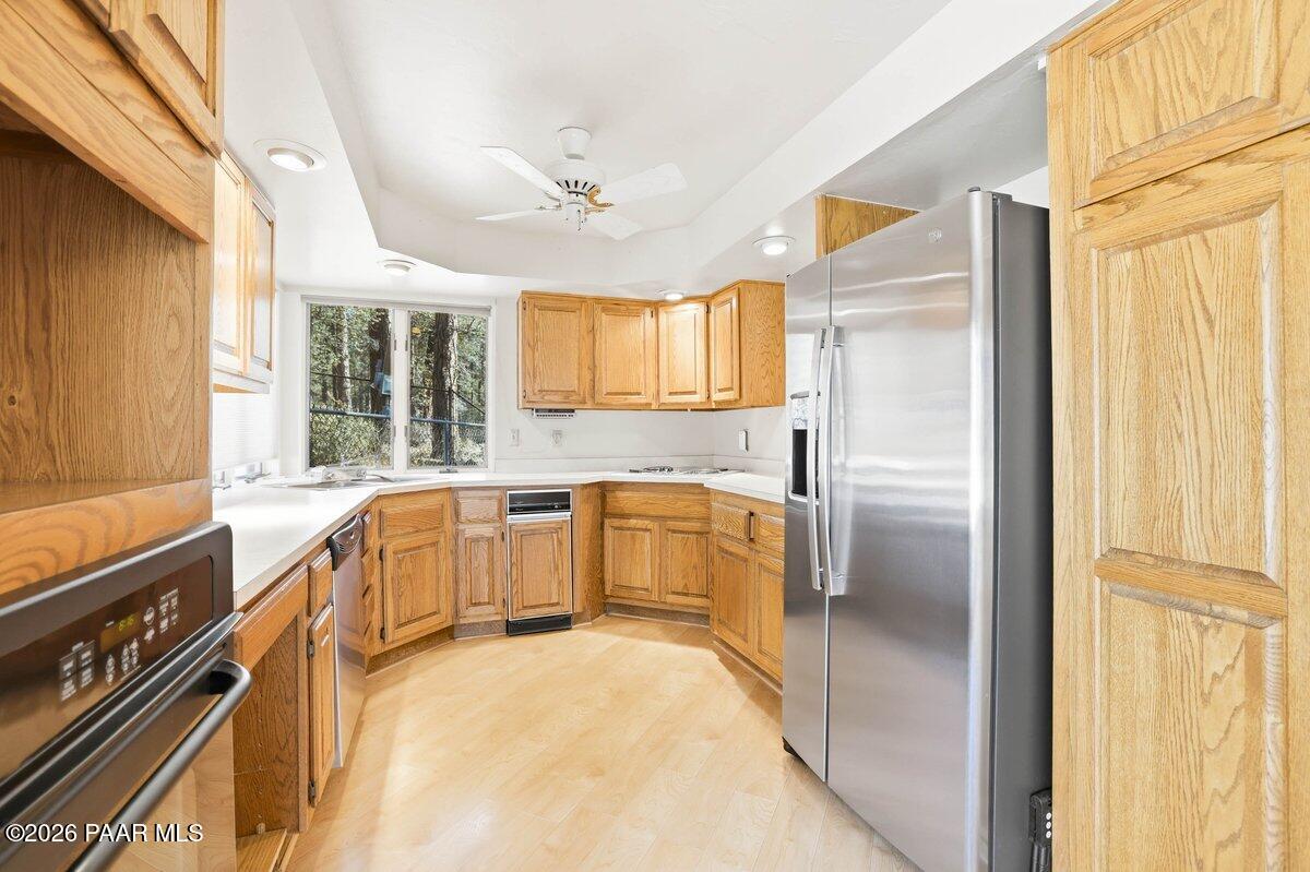 748 East Marapai Road Prescott, AZ 86303 - Photo 17 of 47 a kitchen with a refrigerator a sink and cabinets