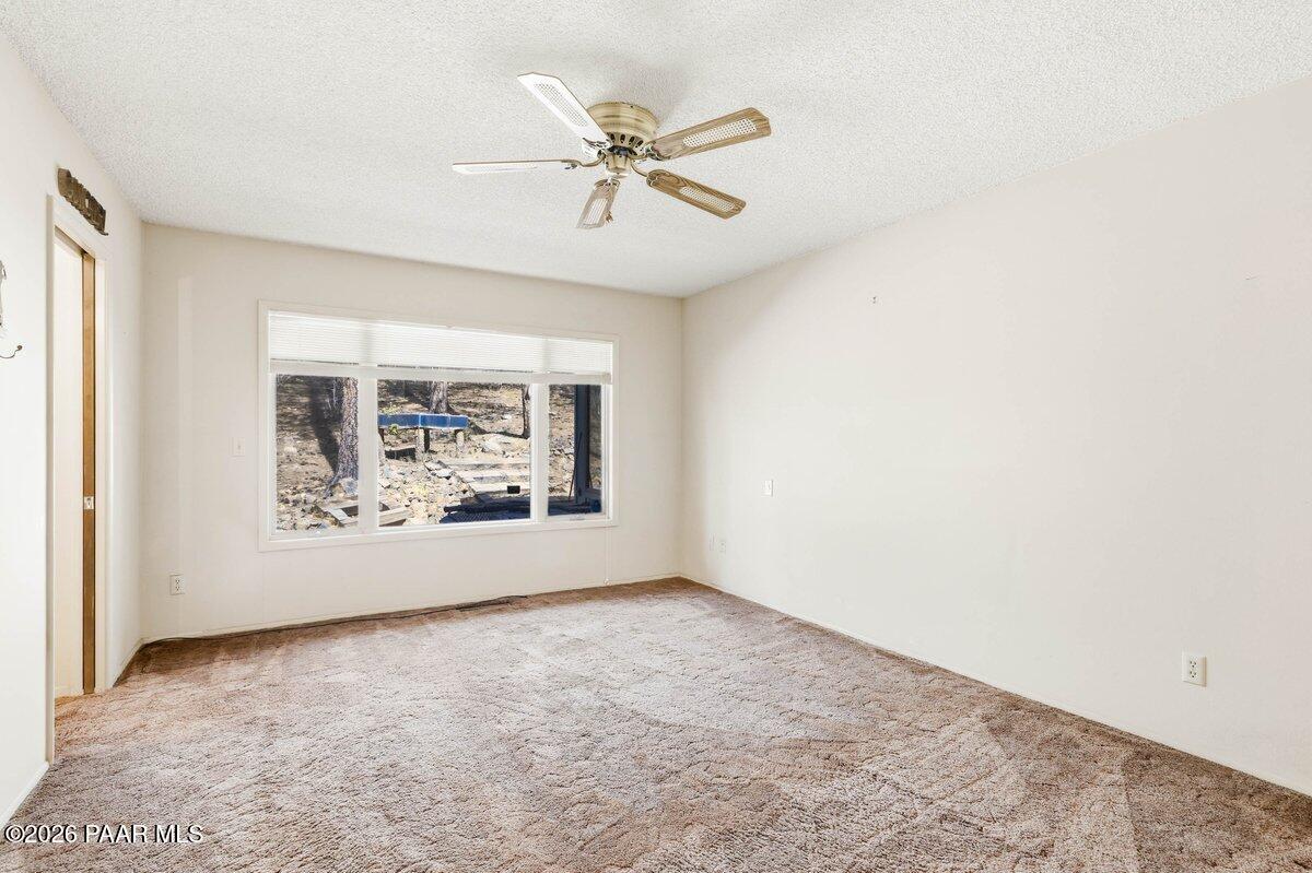 748 East Marapai Road Prescott, AZ 86303 - Photo 21 of 47 an empty room with windows and fan