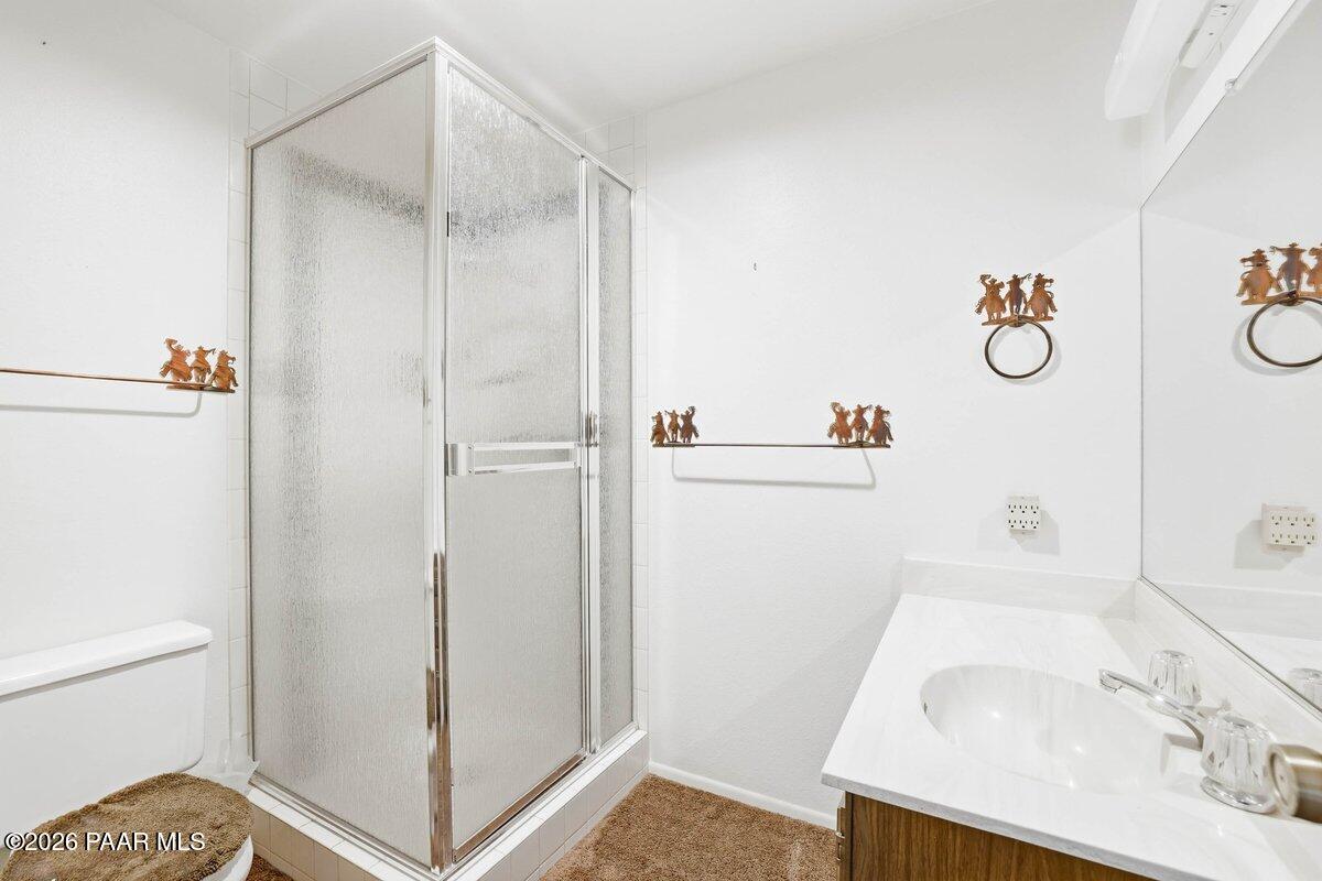 748 East Marapai Road Prescott, AZ 86303 - Photo 24 of 47 a bathroom with a granite countertop sink and a shower