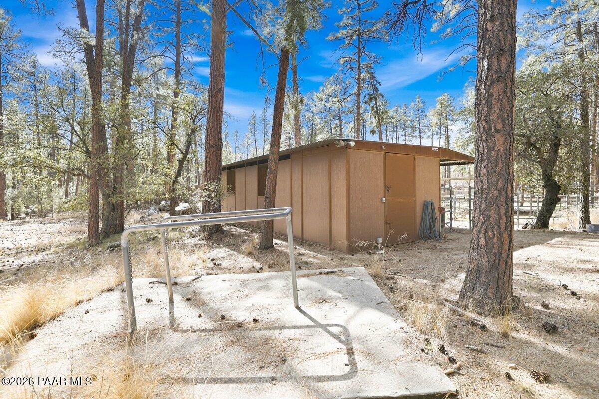 748 East Marapai Road Prescott, AZ 86303 - Photo 30 of 47 a backyard of a house with large trees and wooden fence