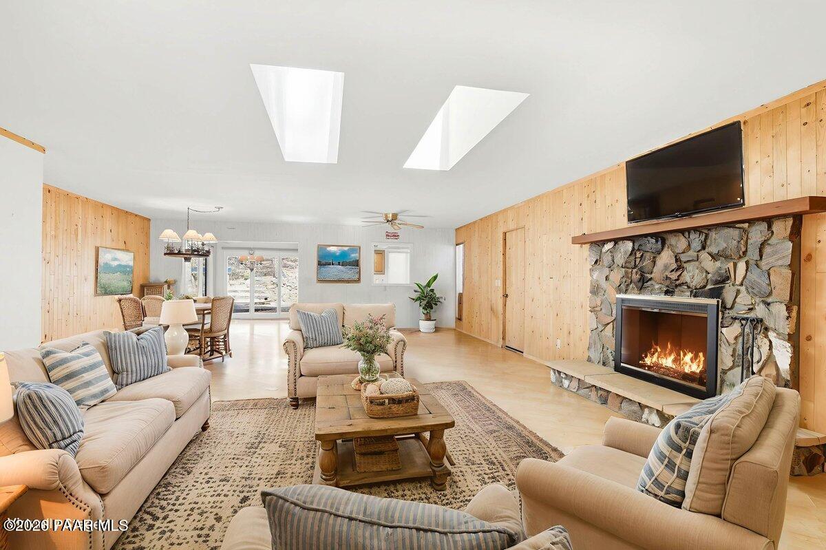 748 East Marapai Road Prescott, AZ 86303 - Photo 8 of 47 a living room with furniture a flat screen tv and a fireplace