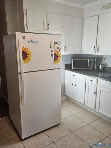 a white refrigerator freezer sitting in a kitchen