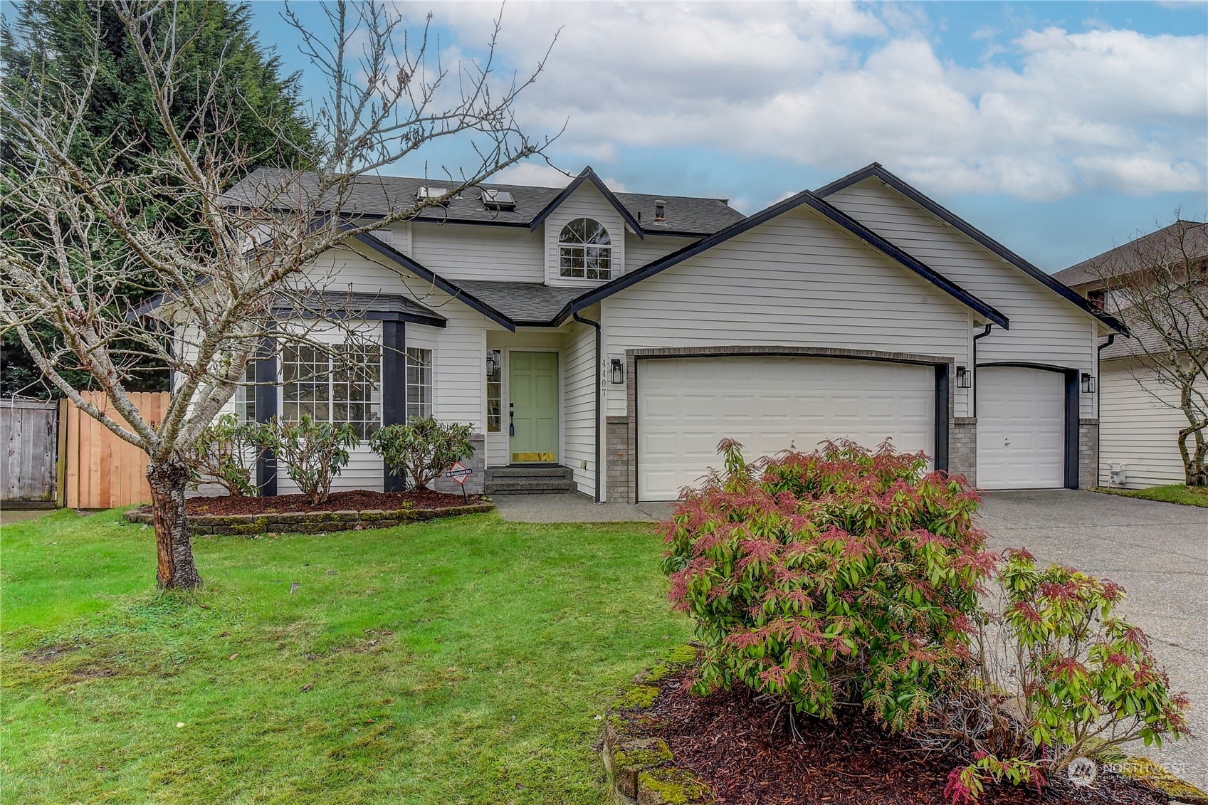 4407 Northeast 6th Place Renton, WA 98059 - Photo 1 of 25 a front view of house with yard and green space