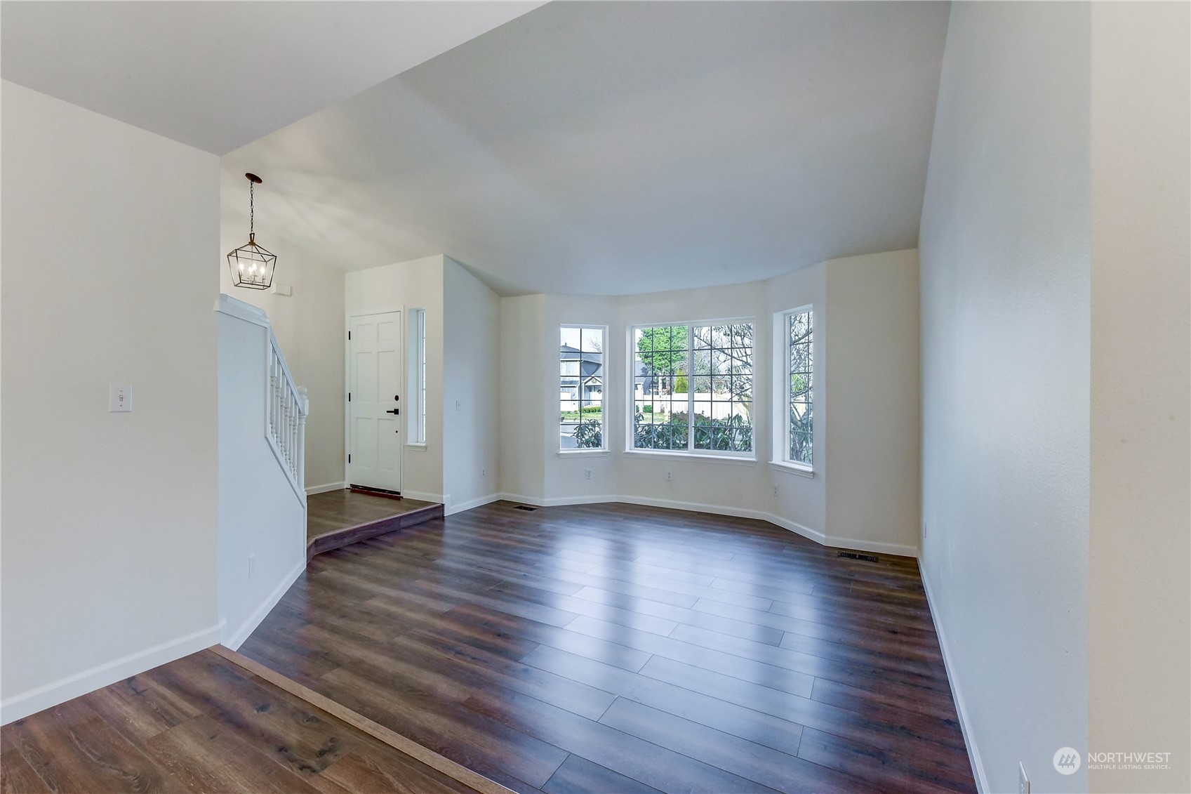 4407 Northeast 6th Place Renton, WA 98059 - Photo 3 of 25 an empty room with wooden floor and windows