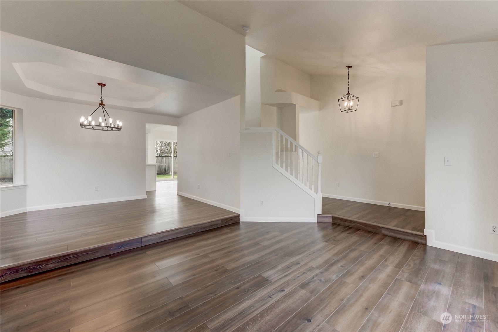 4407 Northeast 6th Place Renton, WA 98059 - Photo 4 of 25 an empty room with wooden floor and chandelier