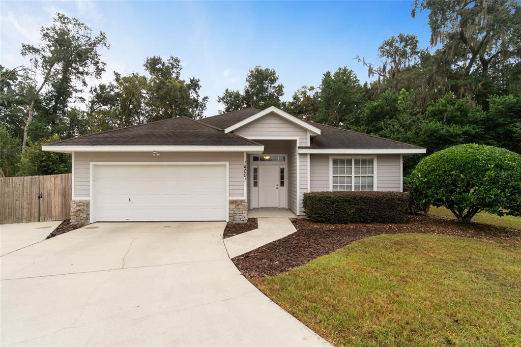 14001 Northwest 9th Road Newberry, FL 32669 - Photo 1 of 1 a front view of a house with a yard and garage