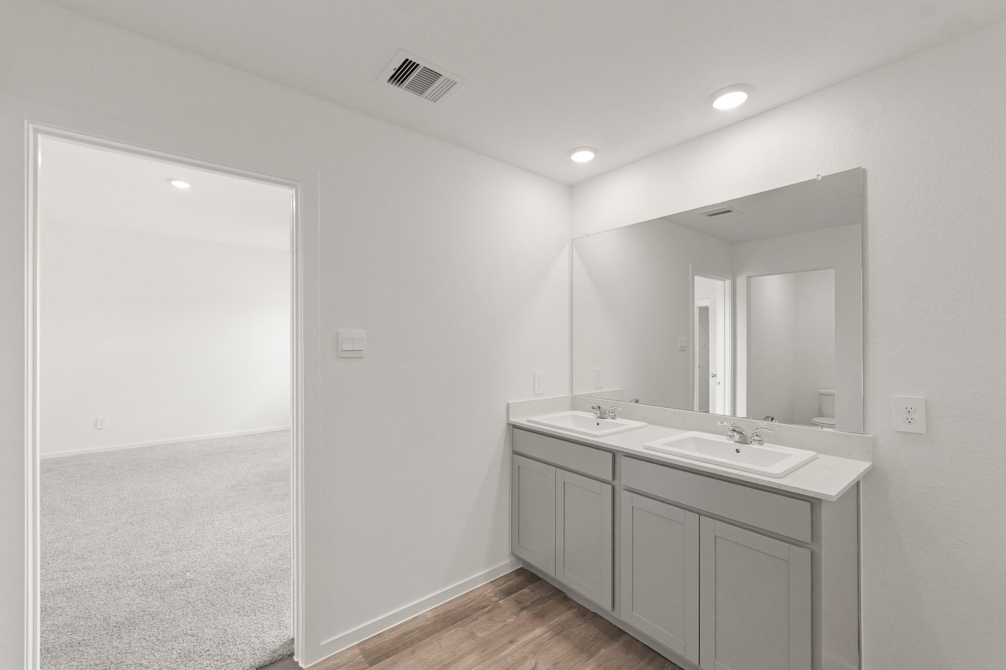 517 Wax Myrtle Way Hockley, TX 77447 - Photo 11 of 17 a bathroom with a double vanity sink and mirror